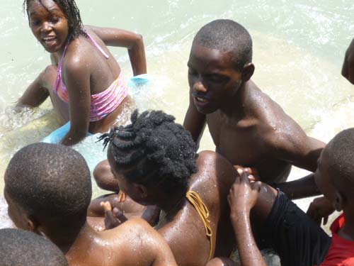 Les enfants du bidonville de Cité Soleil profitent de la plage et de la baignade dans la mer en Haïti.
