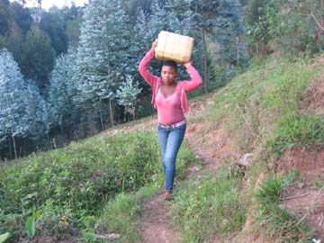 Corvée d'eau au Rwanda : Assumpta porte son bidon d'eau sur la tête